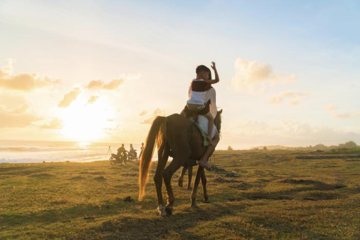 Horse riding at sunset in Sumba, Indonesia.