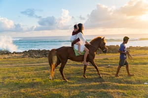 horse riding at Pantai Pero Sumba along the coast during sunset with ocean view