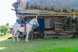 Ratenggaro Village Sumba traditional houses and horse rider in West Sumba Indonesia