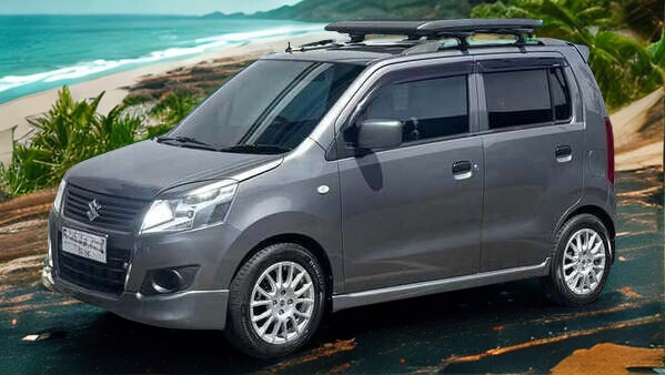 Suzuki Karimun rental car on a coastal road in Sumba Indonesia